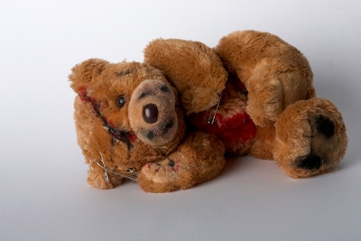 Liegender Plüsch Teddy mit Narben